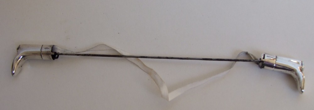 An extremely rare pair of hallmarked silver knitting needle guards.