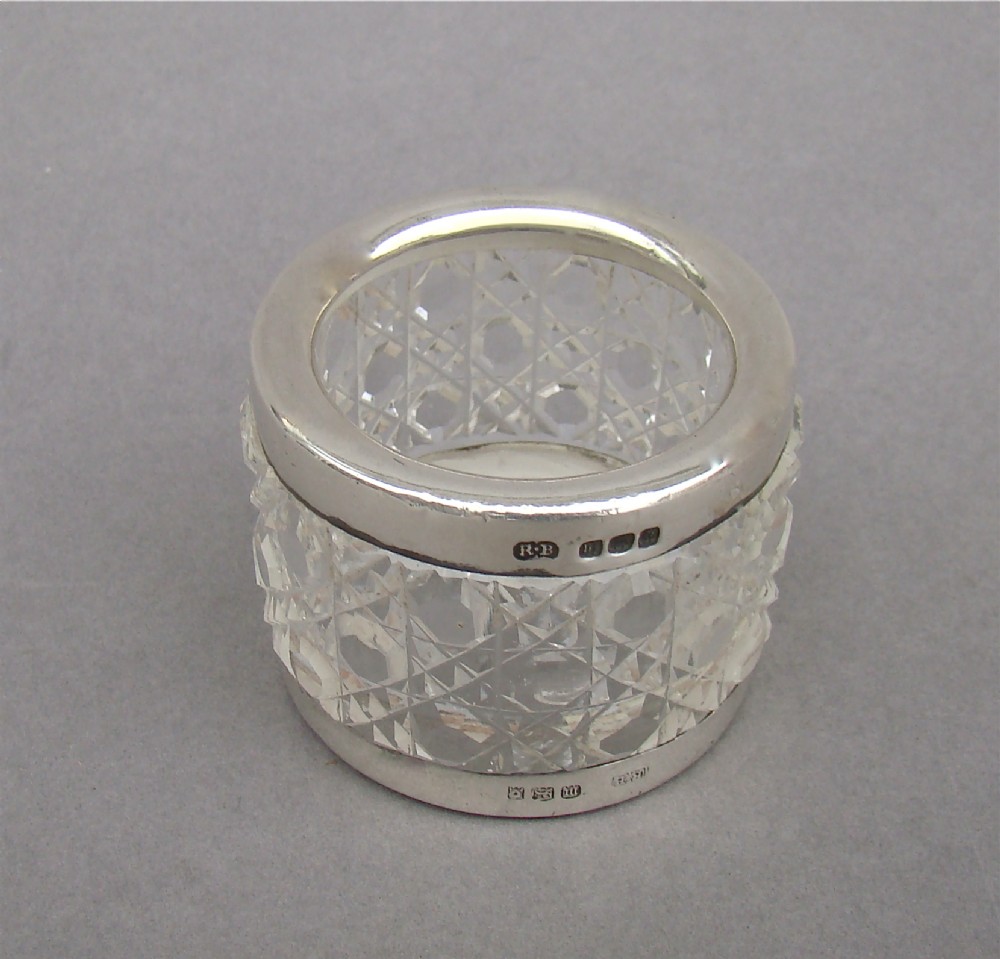 An unusual silver mounted cut glass napkin ring.