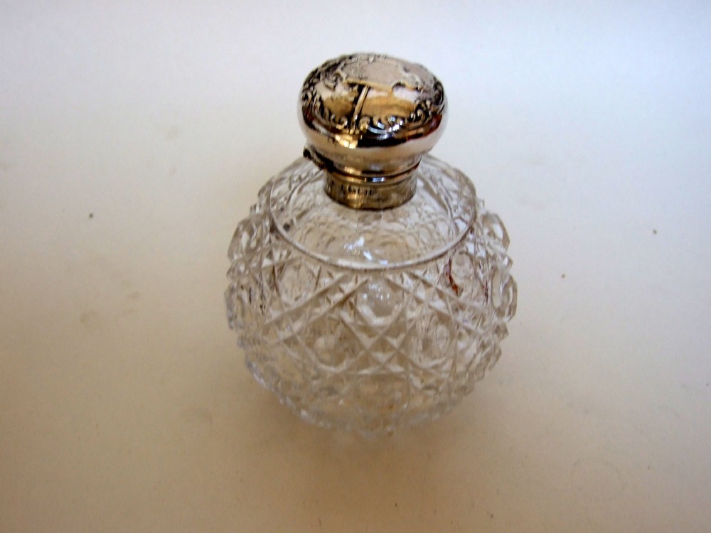 A fine Edwardian silver topped cologne bottle