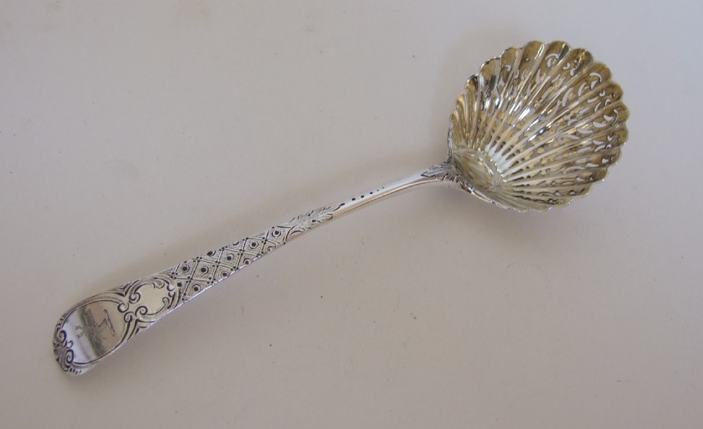 A fabulous mid 18th Century silver sifter spoon.