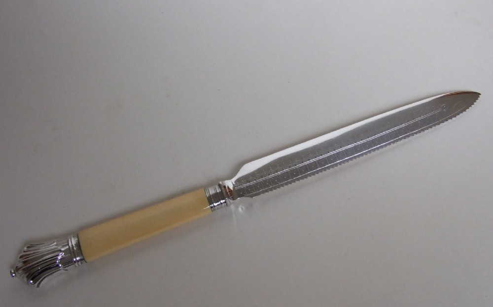 A Victorian silver mounted wedding cake knife.
