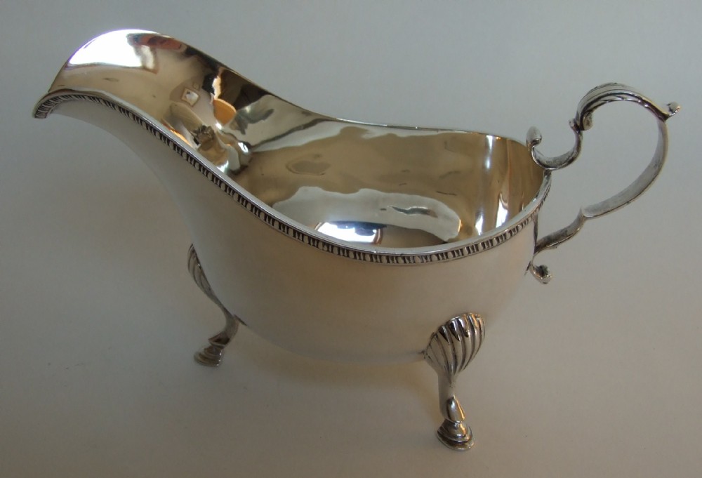 A large Edwardian silver gravy boat.