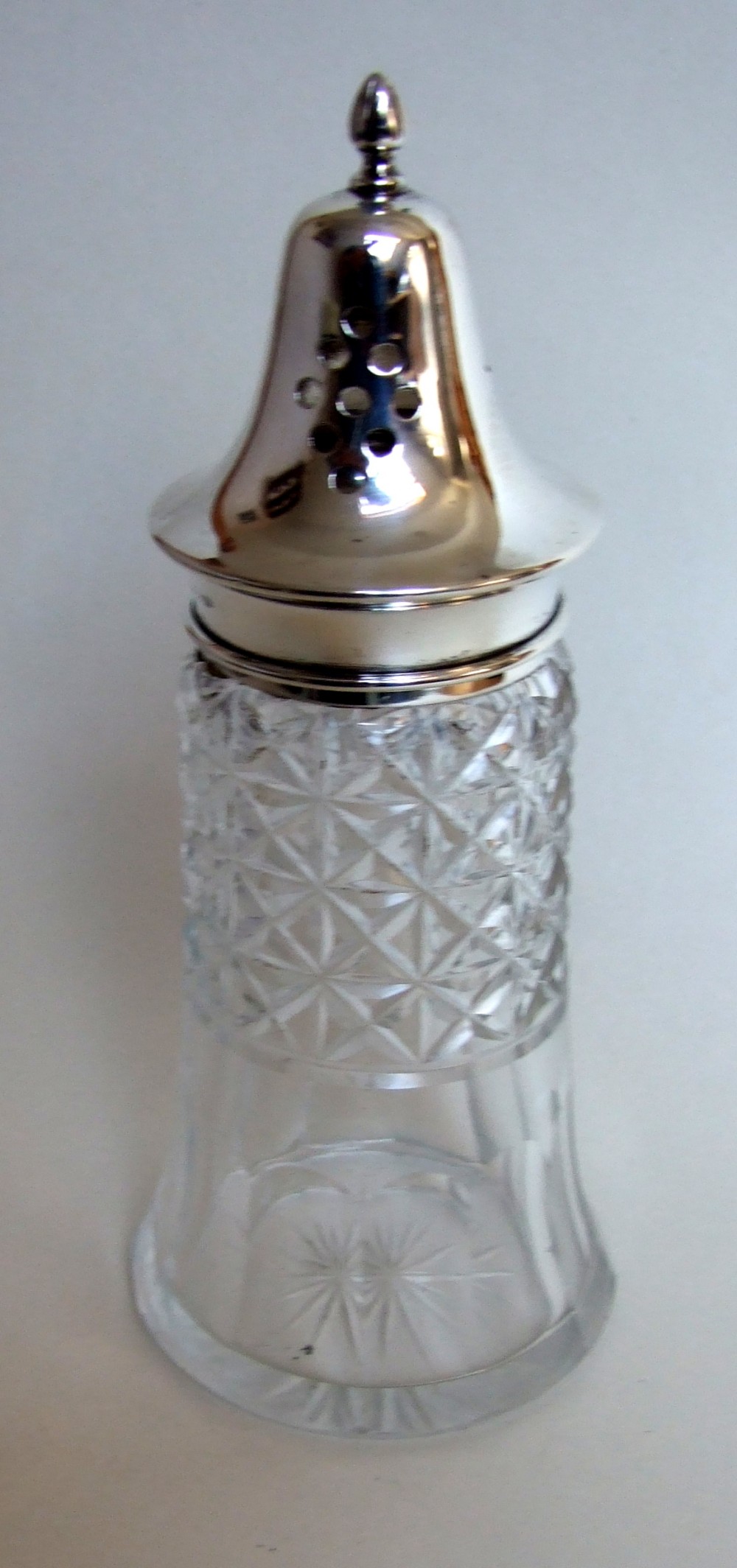 A handsome silver mounted sugar caster.