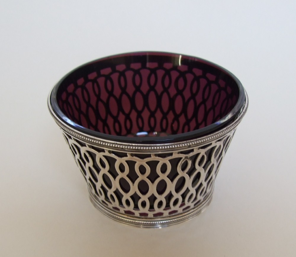 A superb Victorian pierced silver dish with amethyst liner.