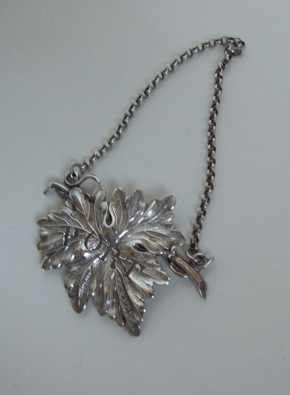 A handsome William IV pierced silver leaf Port label.