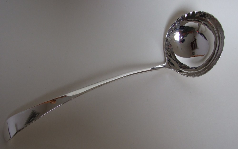 A wonderful George II silver soup ladle.