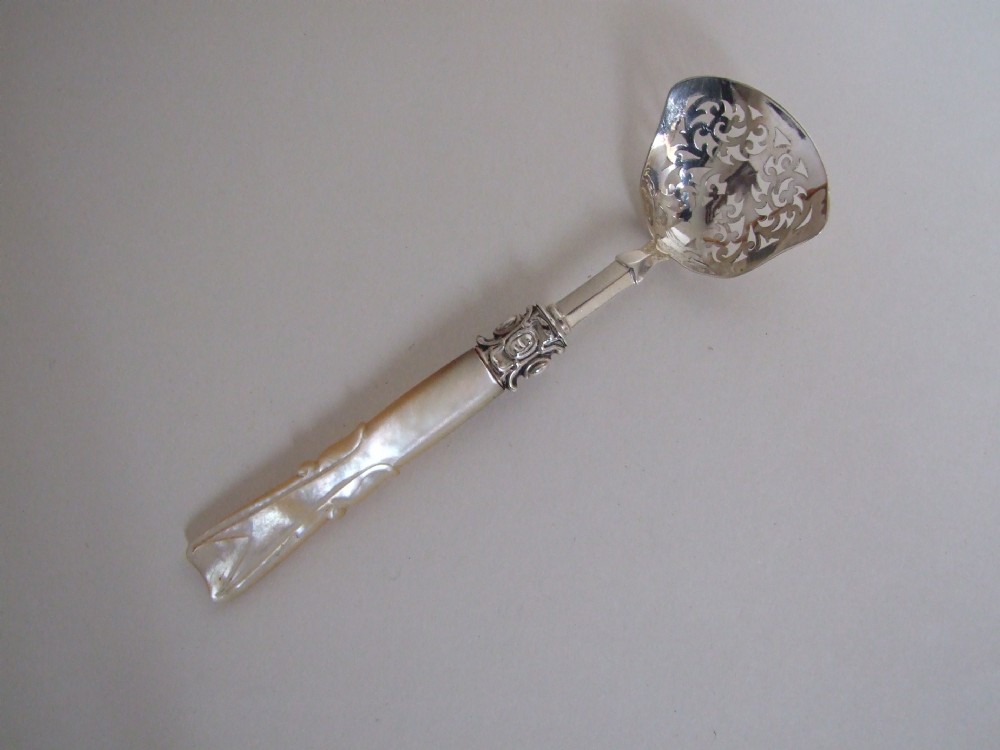 An unusual early Victorian silver & mother-of-pearl sifter spoon.