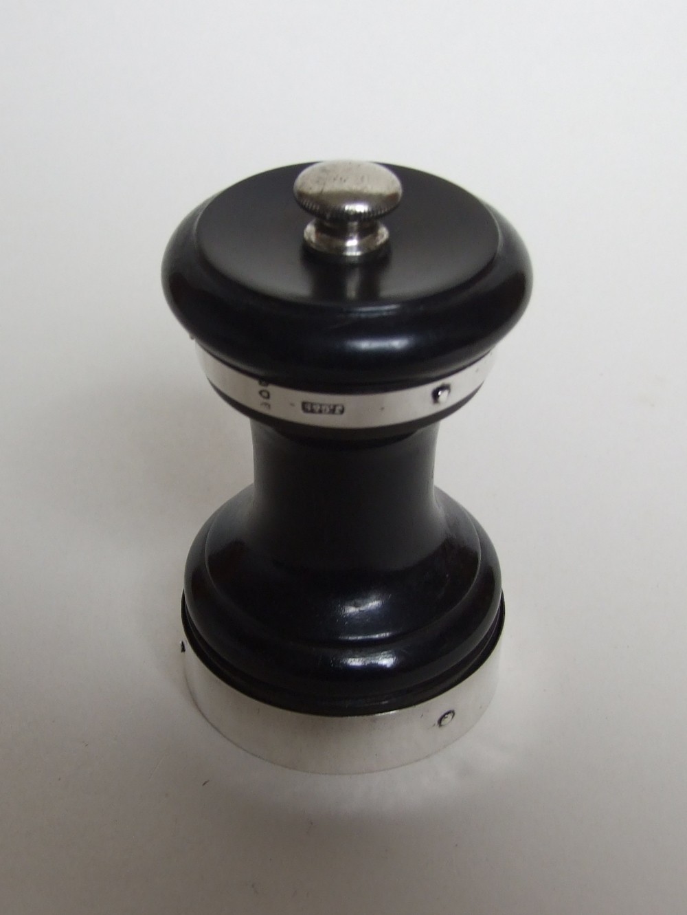 A Victorian silver and ebony pepper grinder.