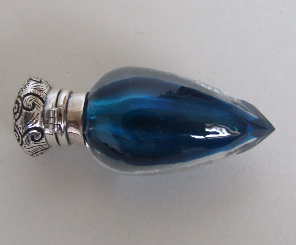 A rare Victorian silver mounted scent bottle in petrol blue.