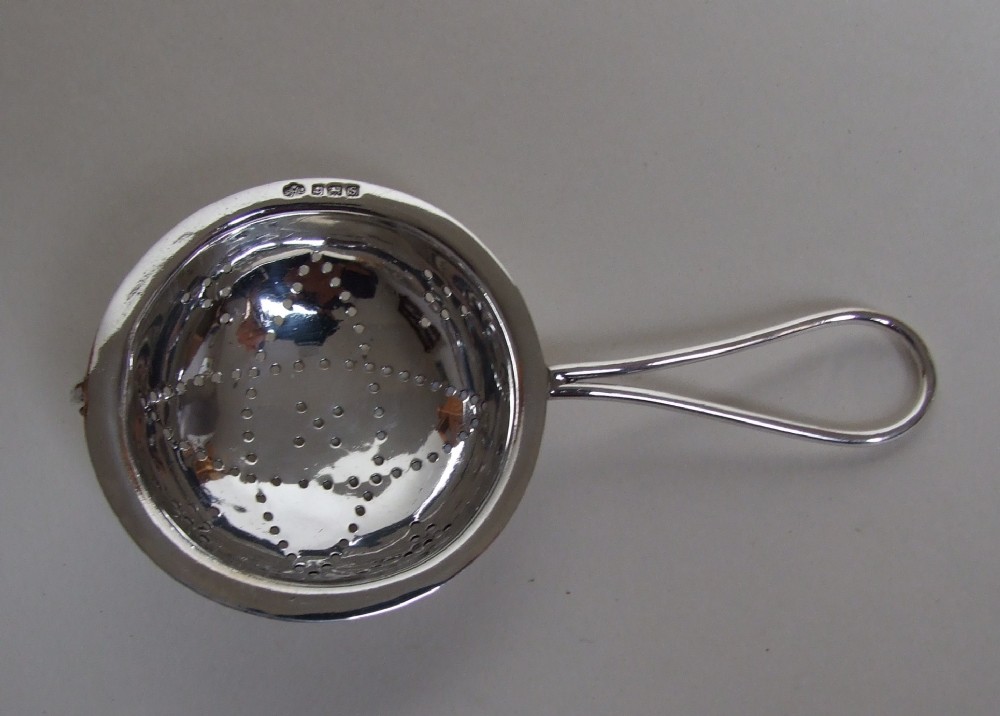 A charming First World War period silver teastrainer.