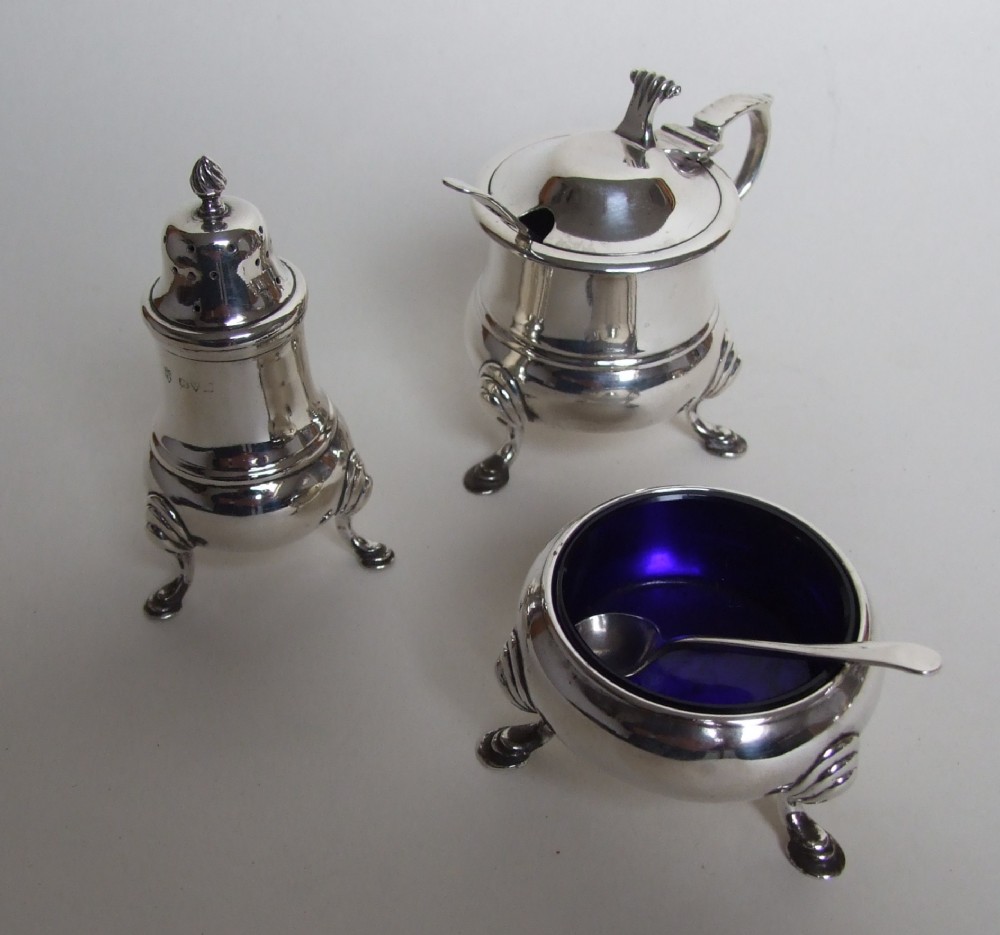A handsome three piece silver cruet with Onlsow pattern thumb grip.