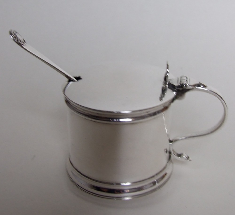 A large silver drum mustard and matching spoon.