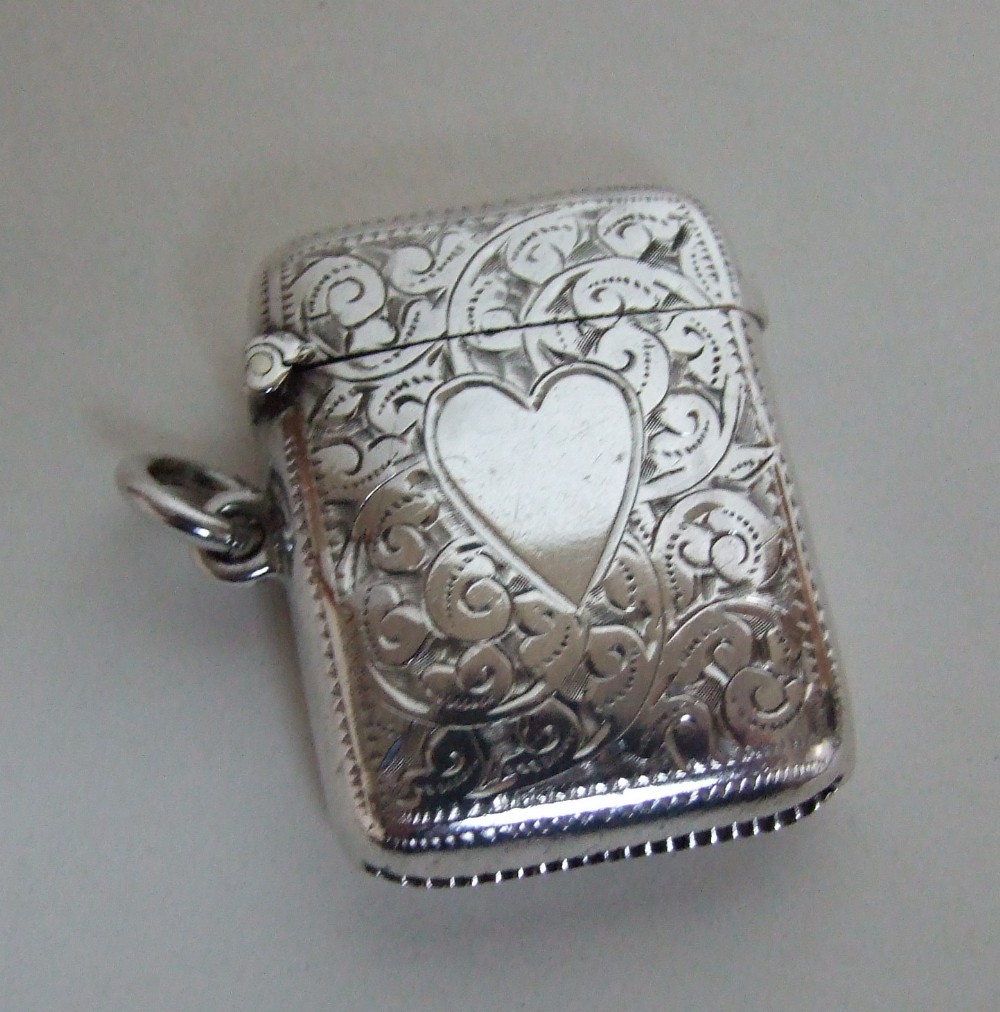 A charming Edwardian silver vesta with heart shaped cartouche.