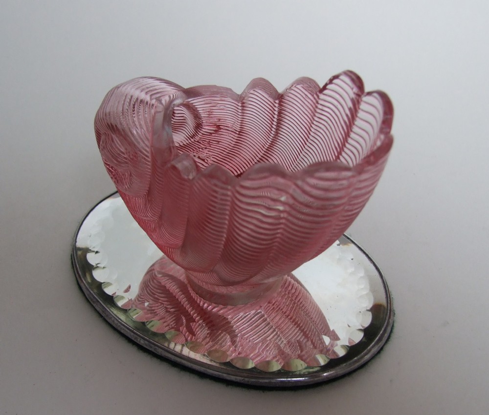 A charming Victorian cranberry bowl on mirror base.