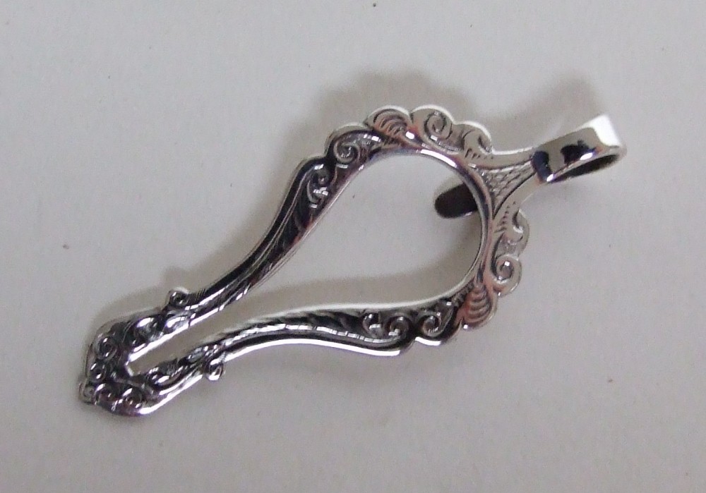 An unusual Victorian silver napkin clip.