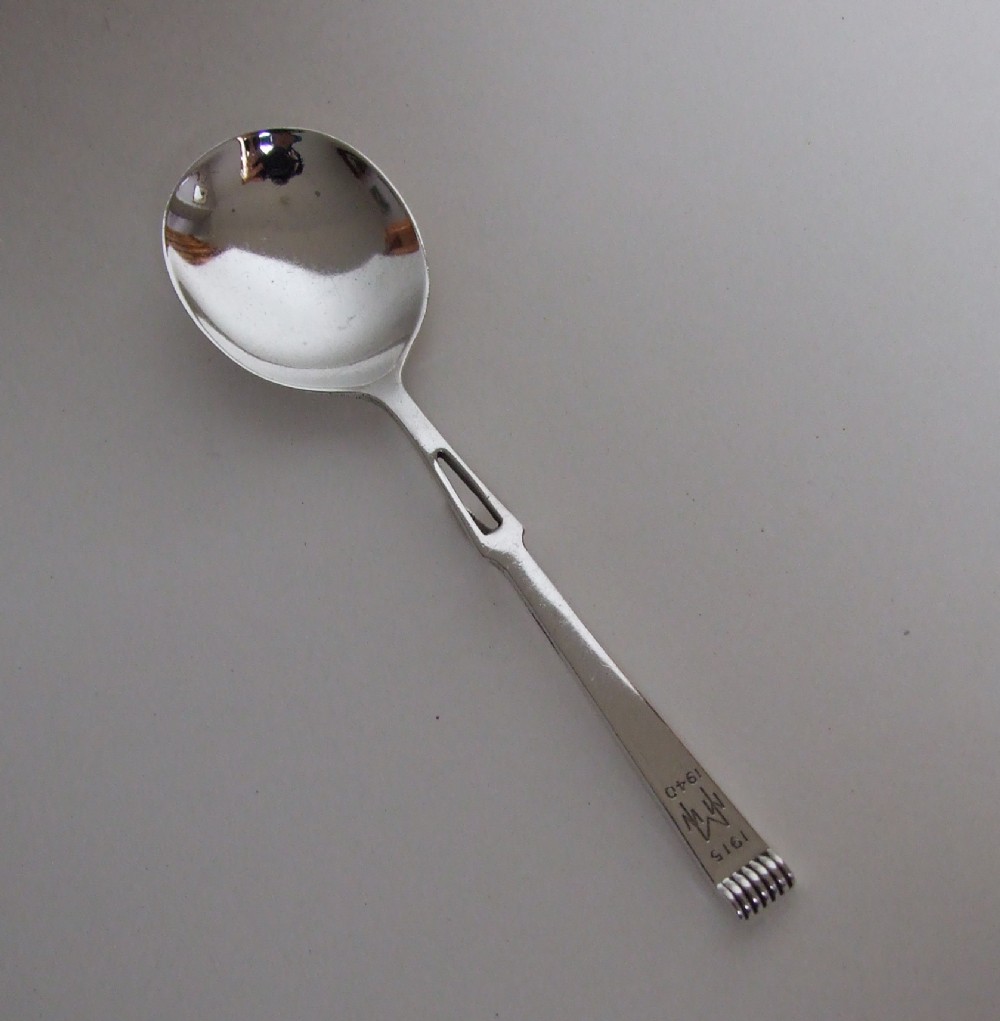 An unusual Art Deco silver honey spoon.
