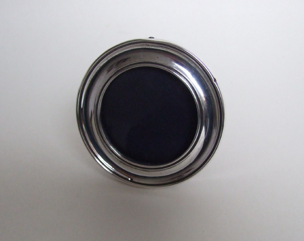 A small round silver photo frame.