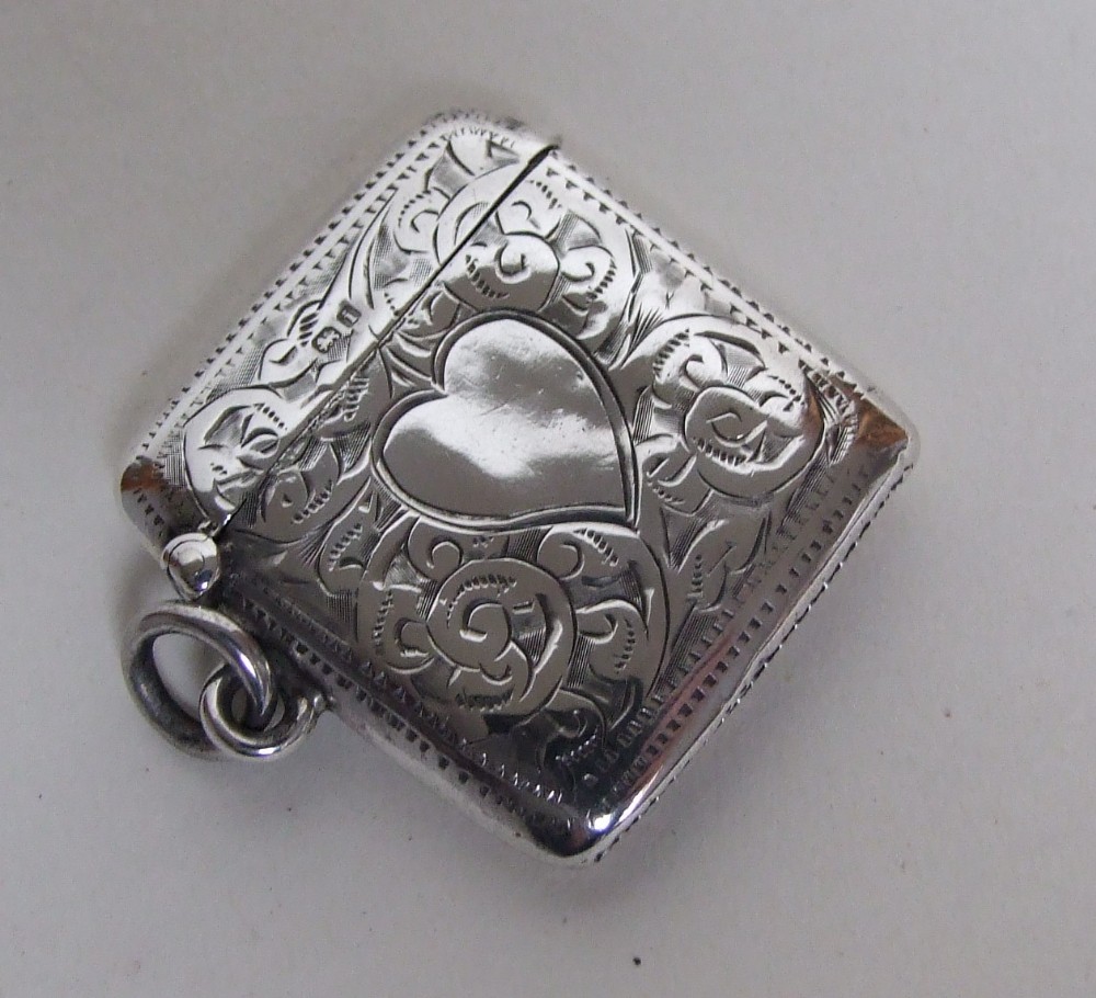 A charming Edwardian silver vesta with heart shaped cartouche.
