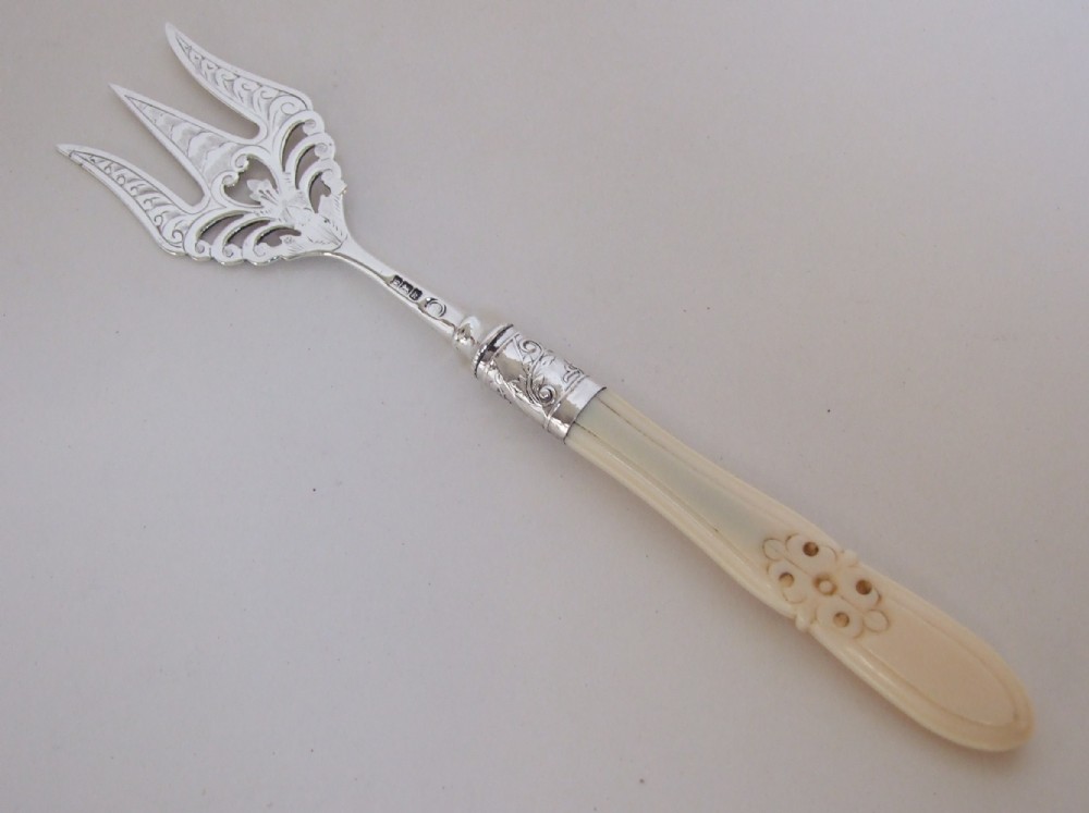 A beautiful pierced silver serving afternoon tea fork.