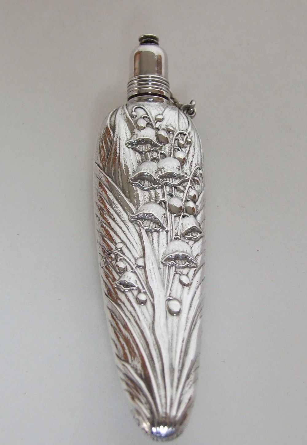 A stunning Sterling silver scent flask with Lily of the Valley motifs.