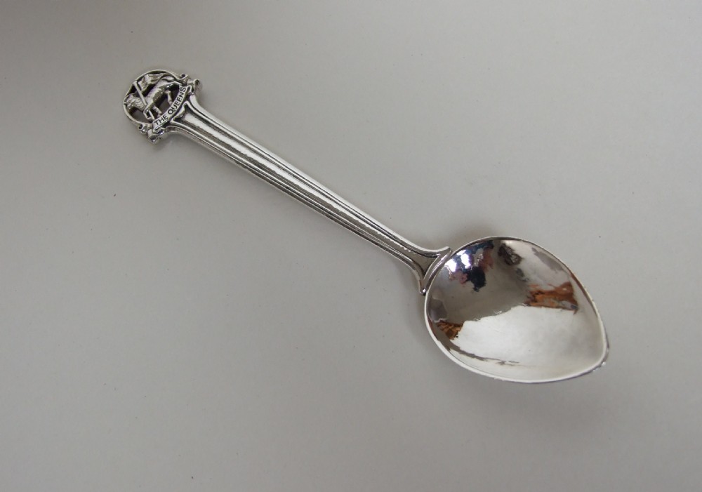 An exceptional Omar Ramsden 'Queens Regiment' silver spoon.