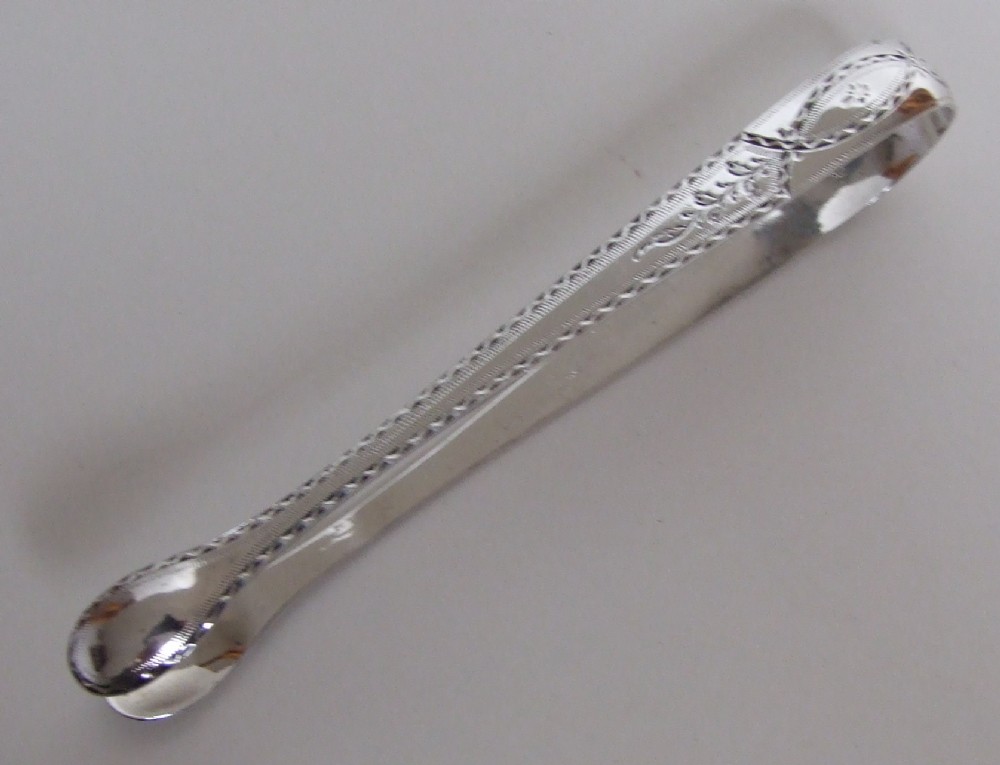 A beautiful pair of late 18th Century silver tongs.