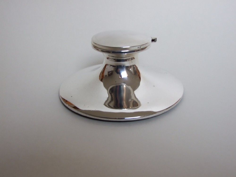 A stylish George V silver capstan inkwell.