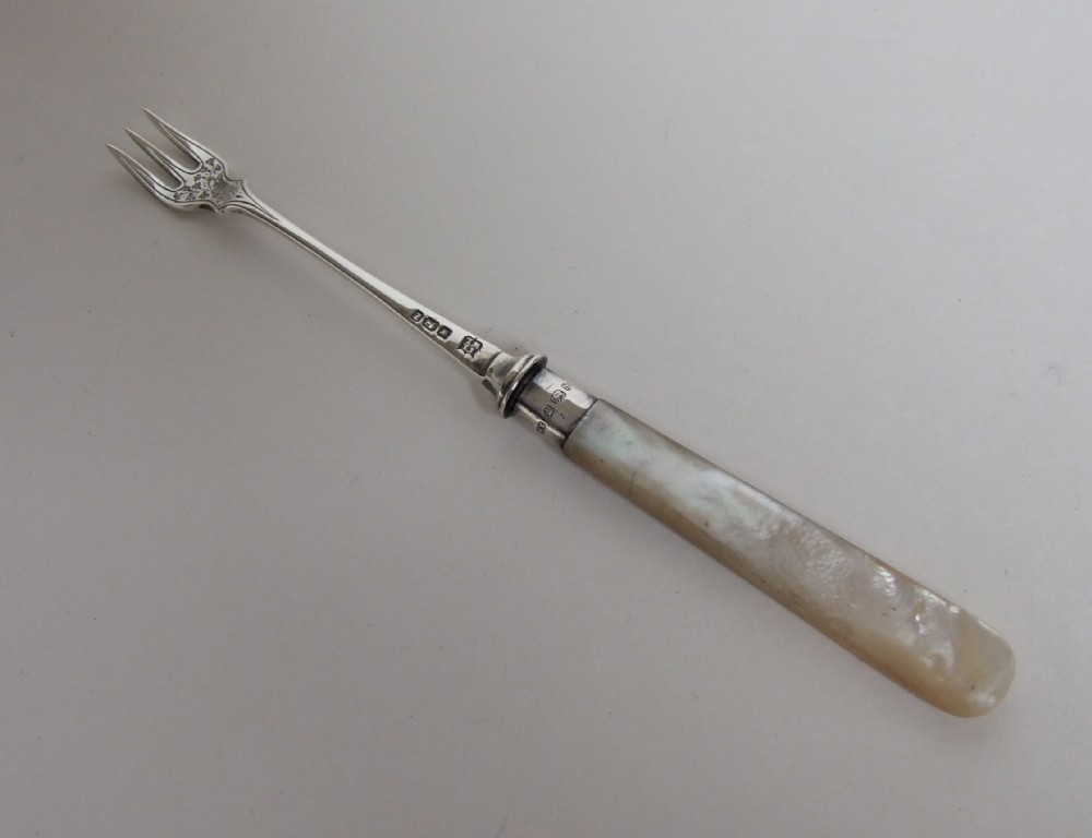 A charming Victorian silver pickle fork.