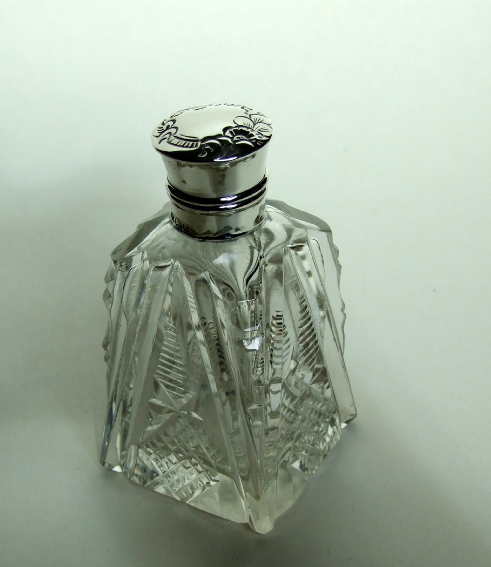 An Edwardian silver mounted cologne bottle.