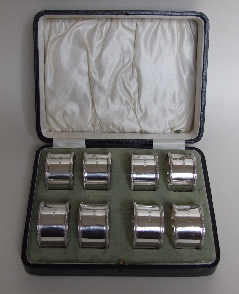 An extremely rare set of 8 boxed silver napkin rings.