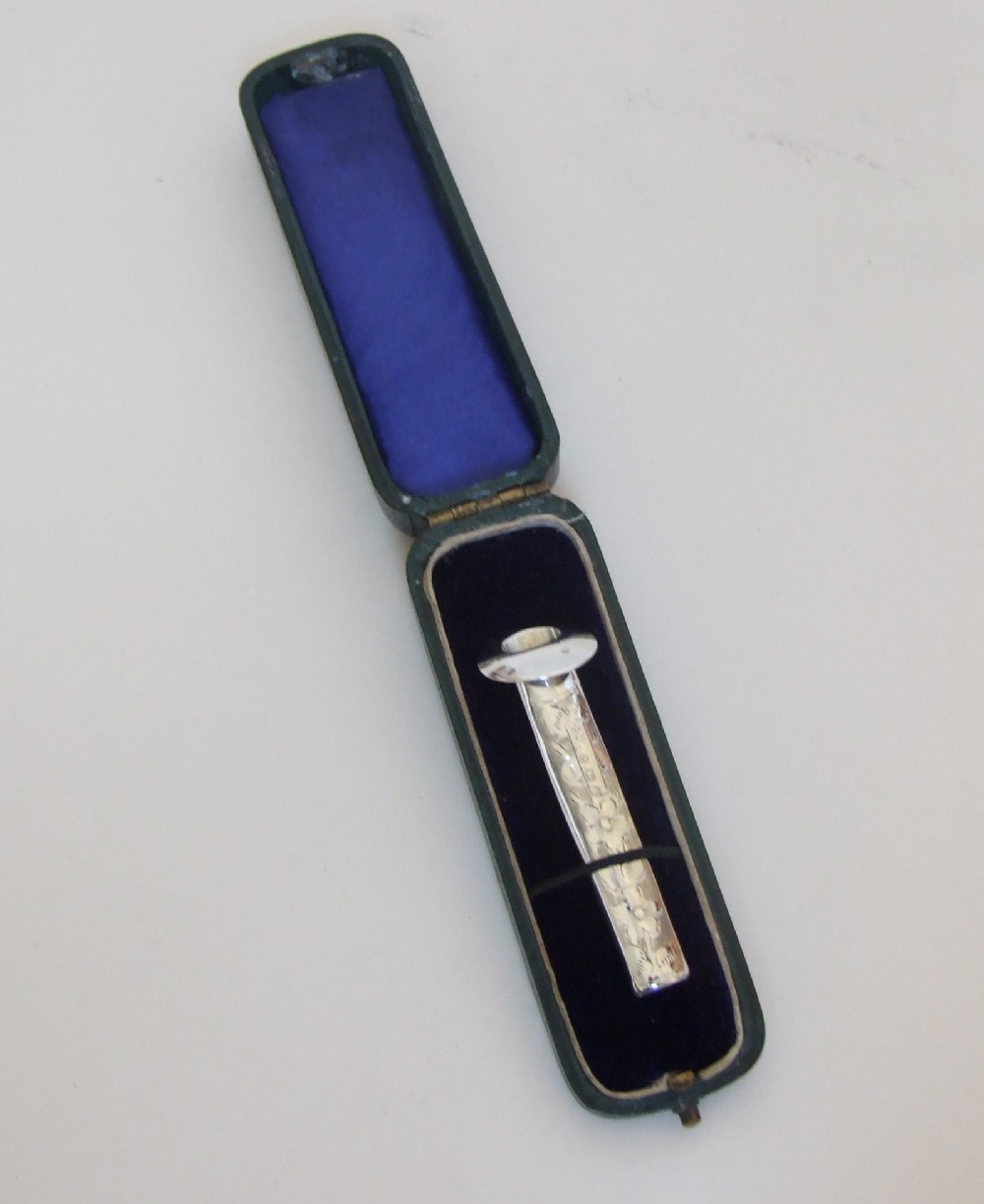 An extremely rare Victorian silver button hole holder, in the original box.