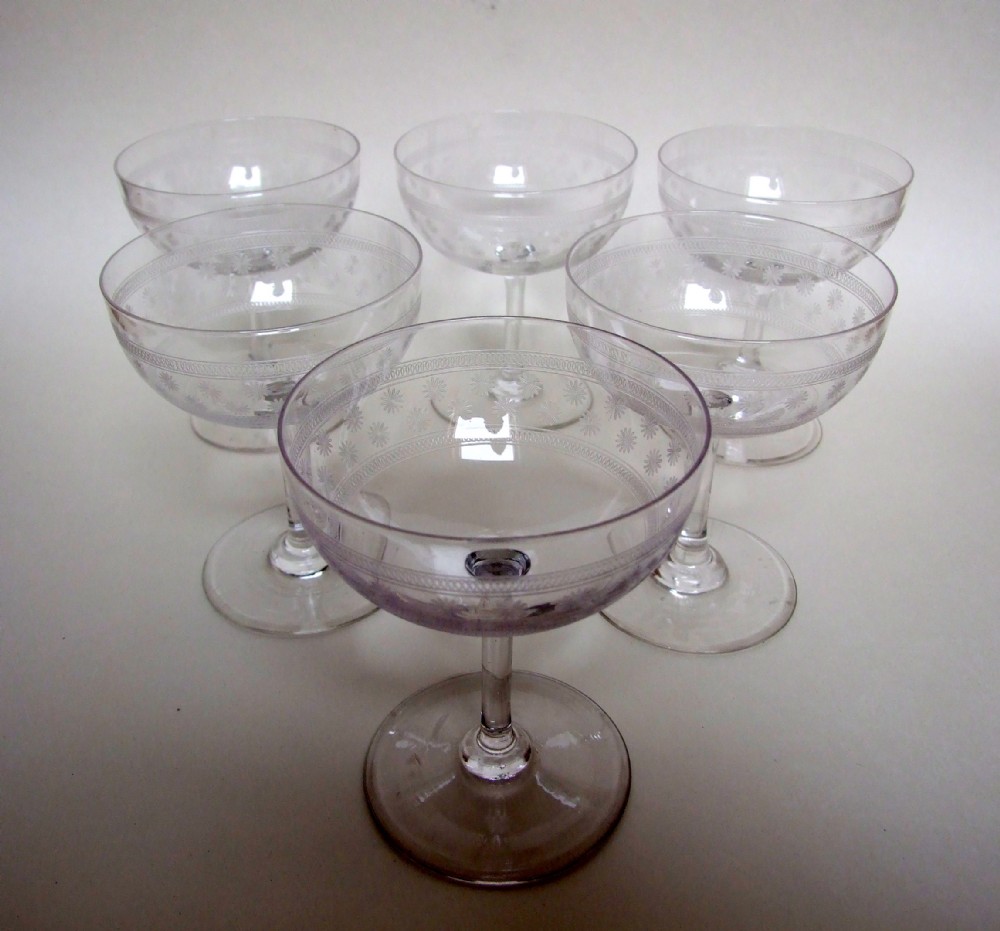 Six etched Edwardian champagne bowls.