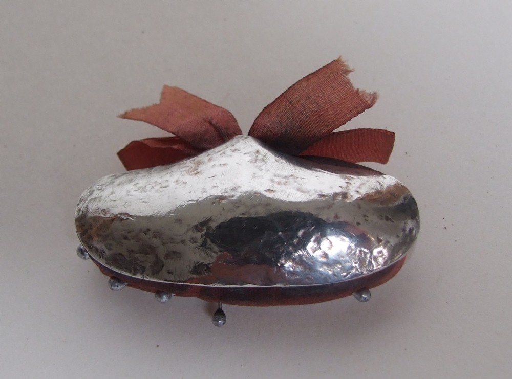 A rare Georgian silver novelty pincushion in the form of a mussel shell.