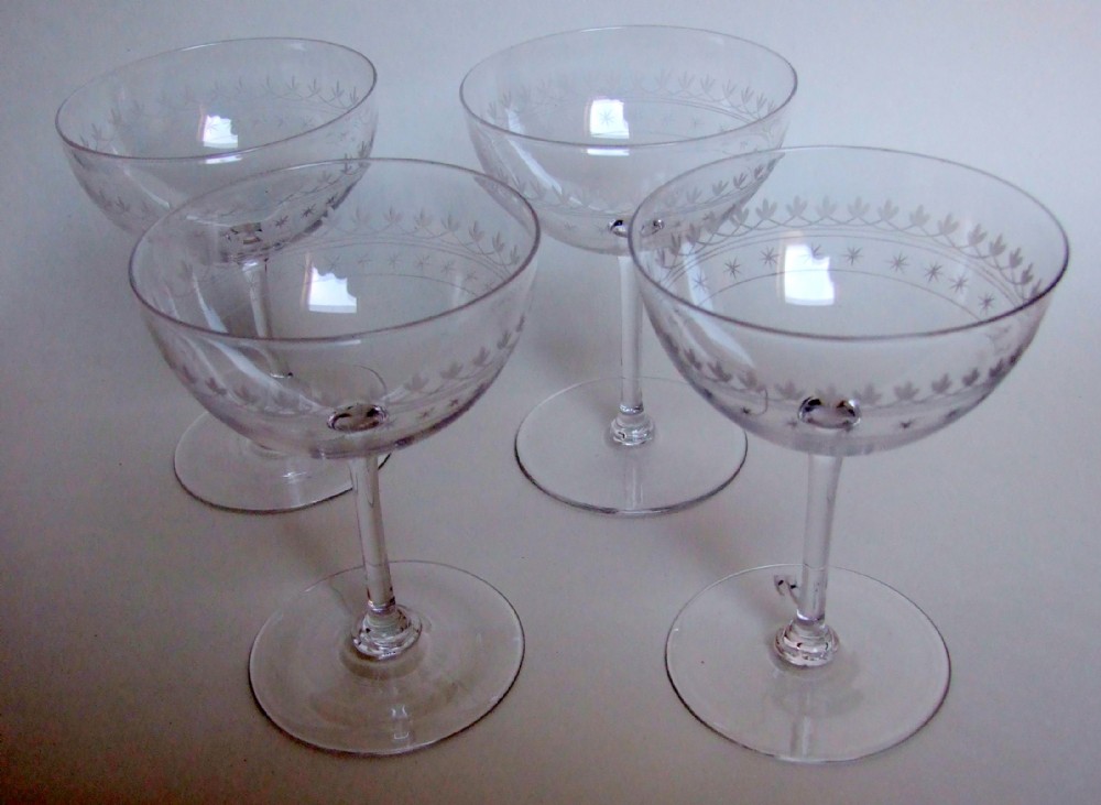 A lovely set of four Victorian etched champagne glasses.