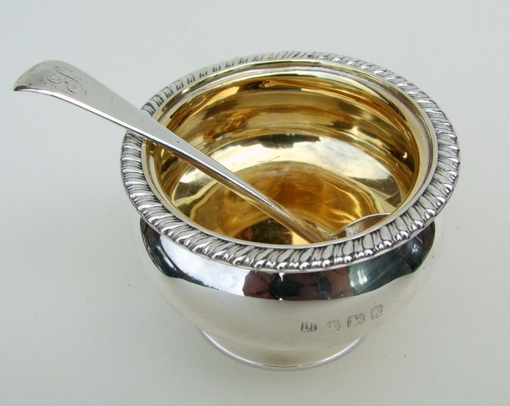 A handsome silver gilt condiment bowl and ladle.