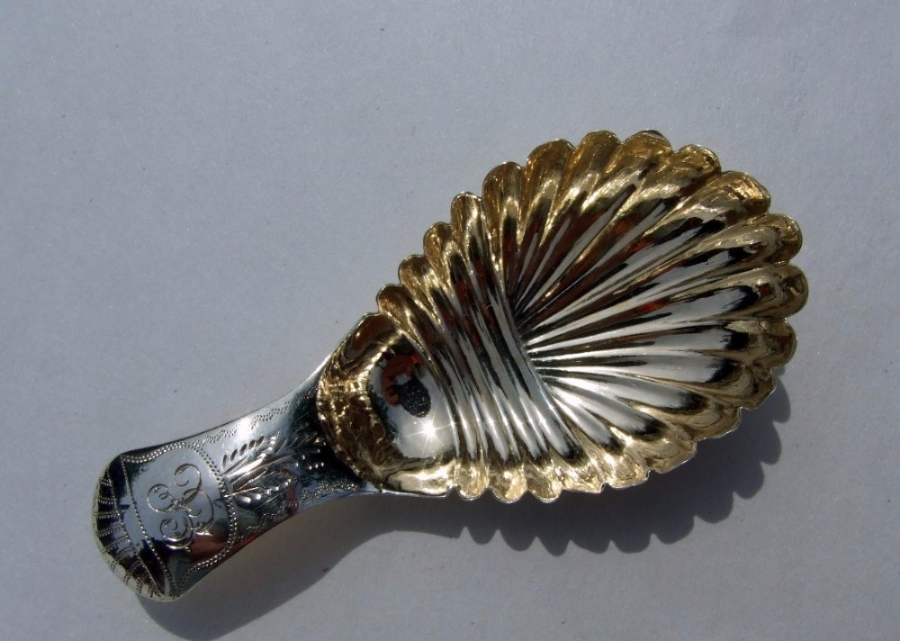 A gorgeous William IV silver gilt caddy spoon.