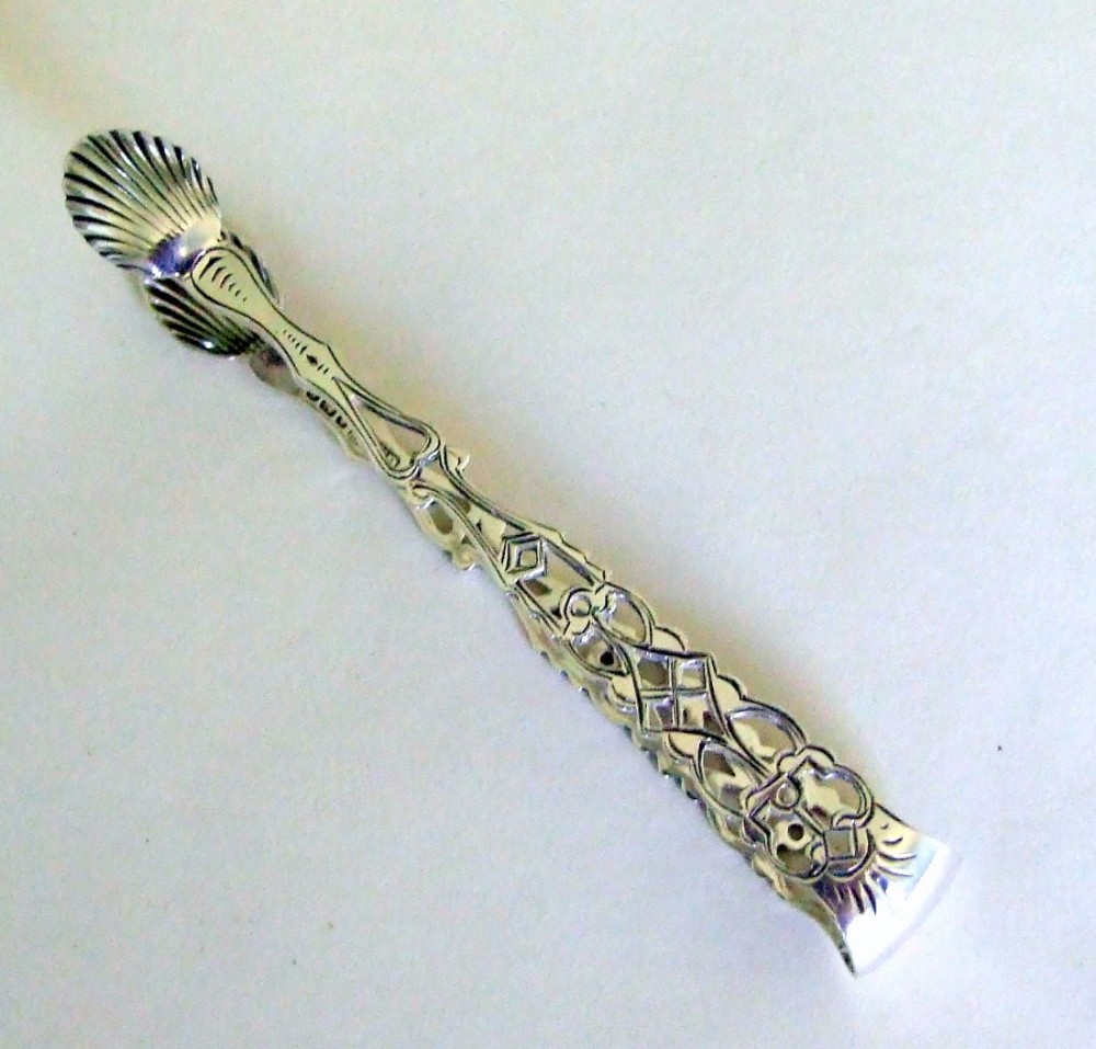 A gorgeous pair of pierced silver tea tongs in the Georgian style.