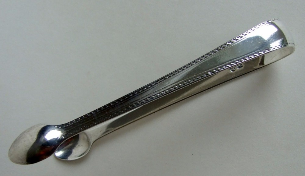 A charming pair of 18th Century silver tongs.