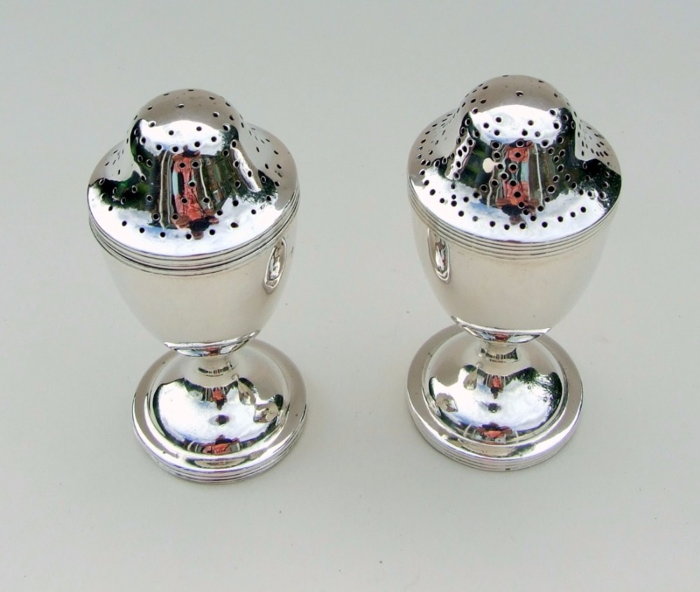 A lovely pair of George V silver pepper pots.