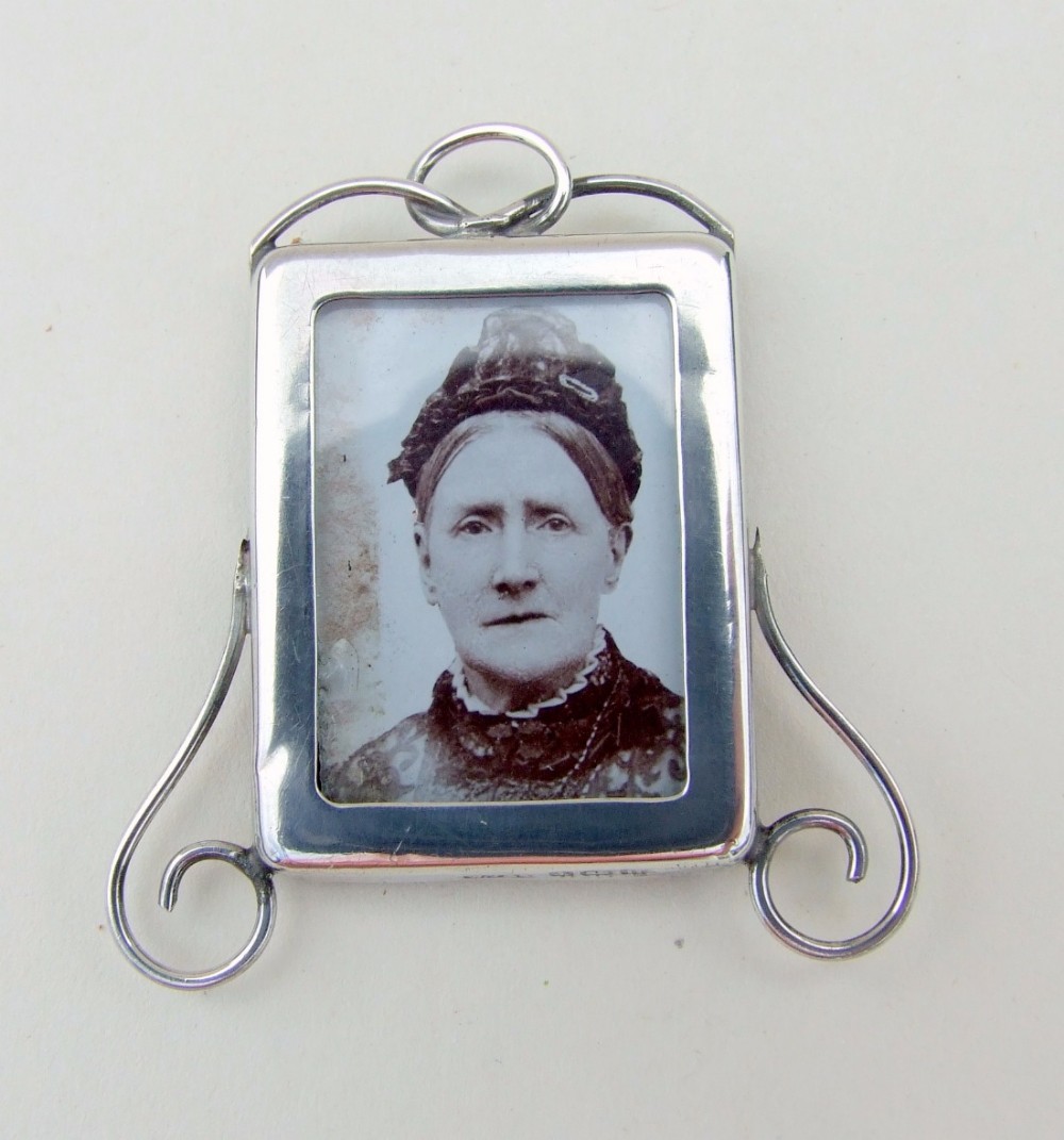 A charming miniature silver photo frame.