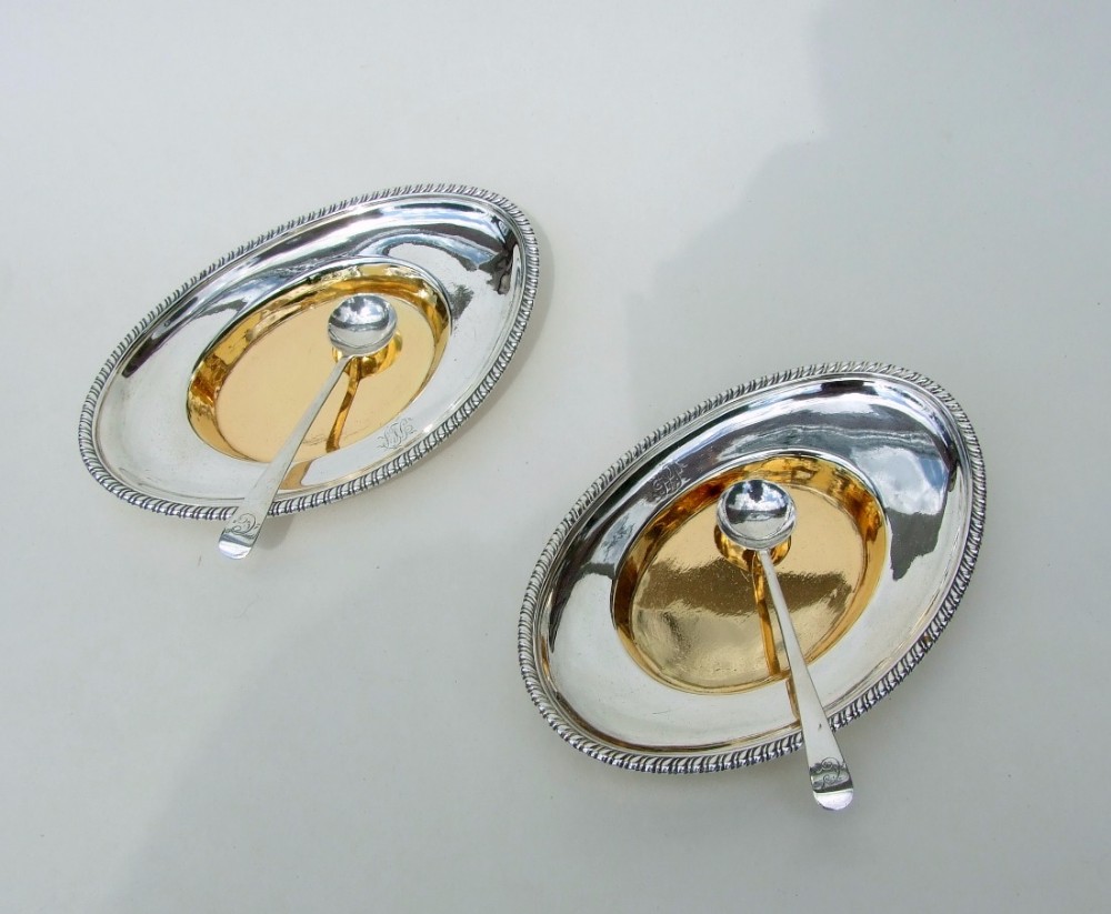 A rare pair of Georgian silver gilt condiment trays with spoons.