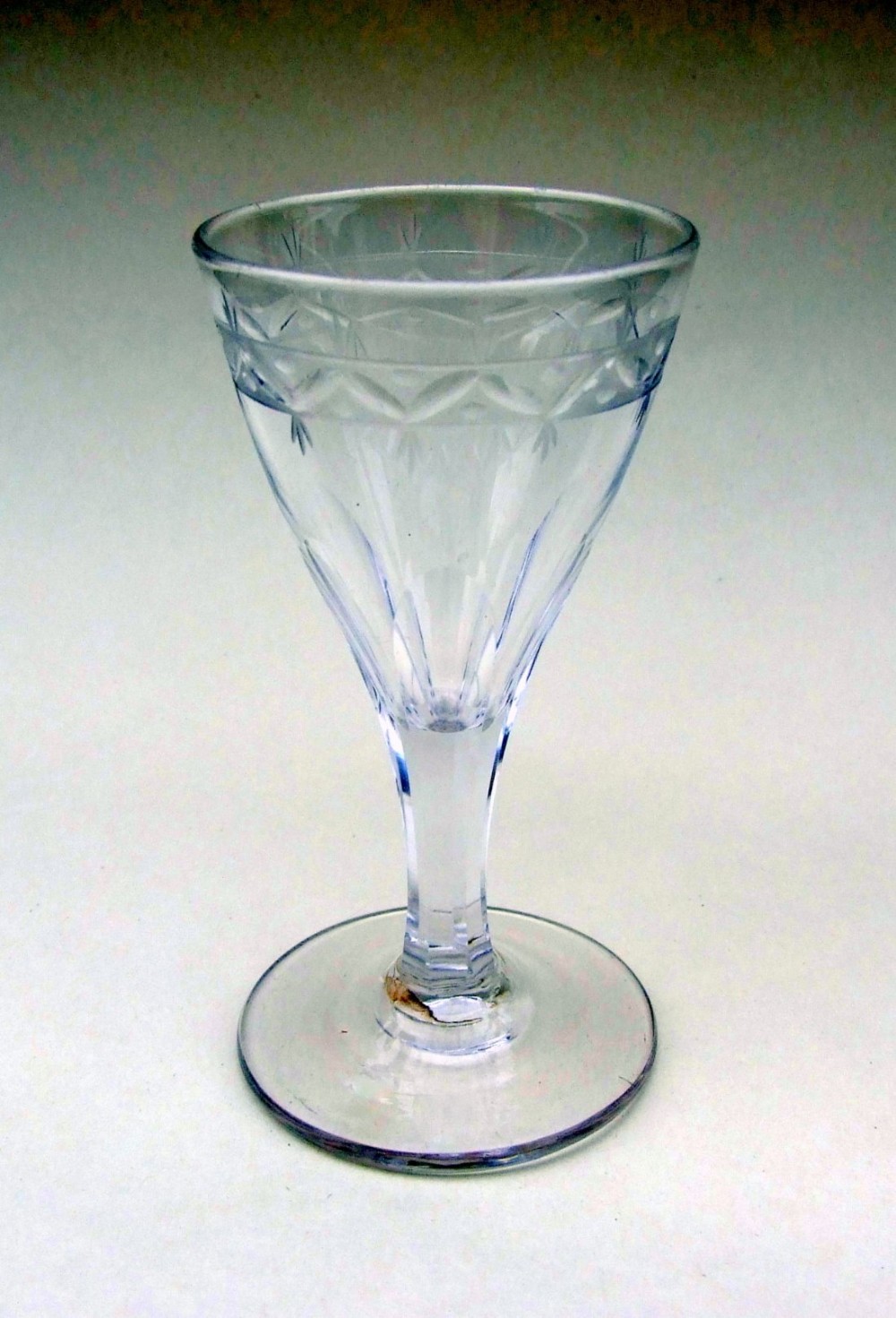 An 18th Century etched and cut dram glass.