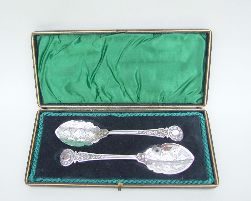 A pair of boxed Victorian silver plated preserve spoons.