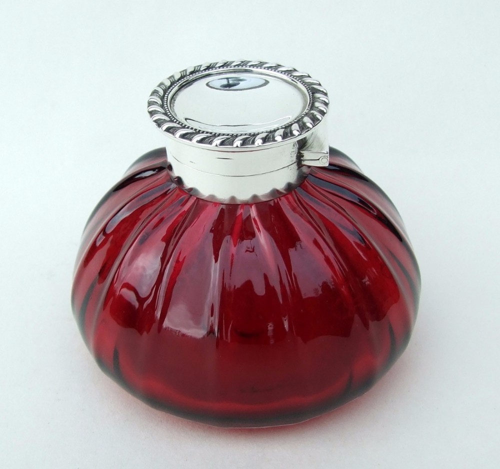 A fabulous Victorian silver mounted cranberry inkwell.