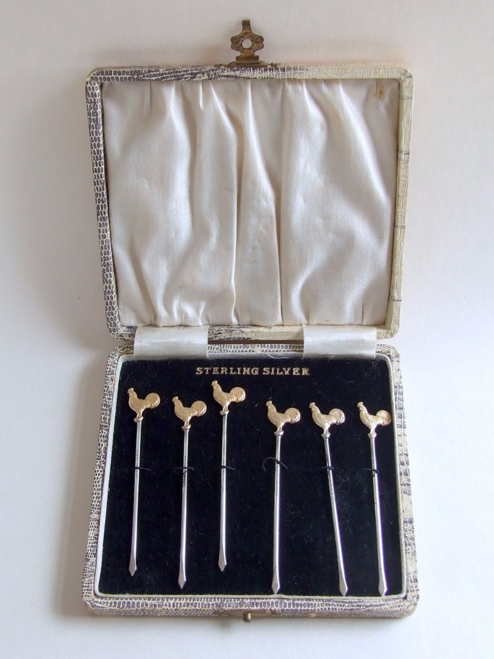 A rare set of Sterling silver gilt cockerel cocktail sticks in the original box.