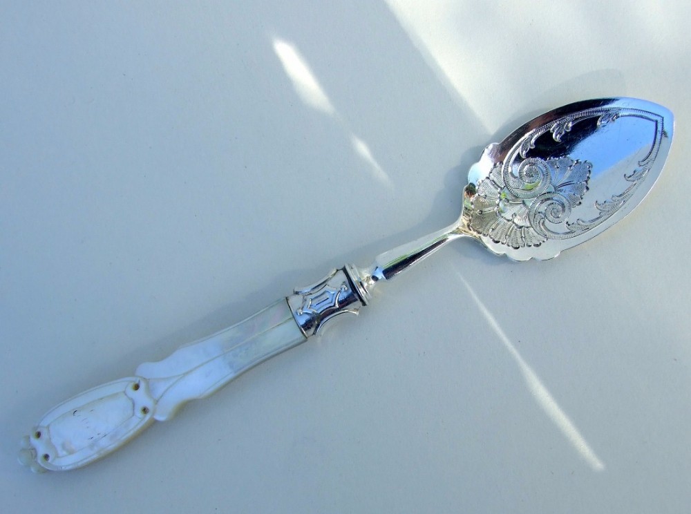 A splendid Victorian silver & mother of pearl preserve spoon.