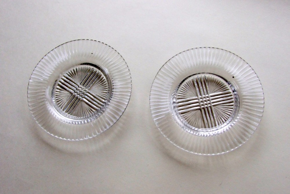 A lovely pair of Regency cut glass saucers/wine glass coasters.