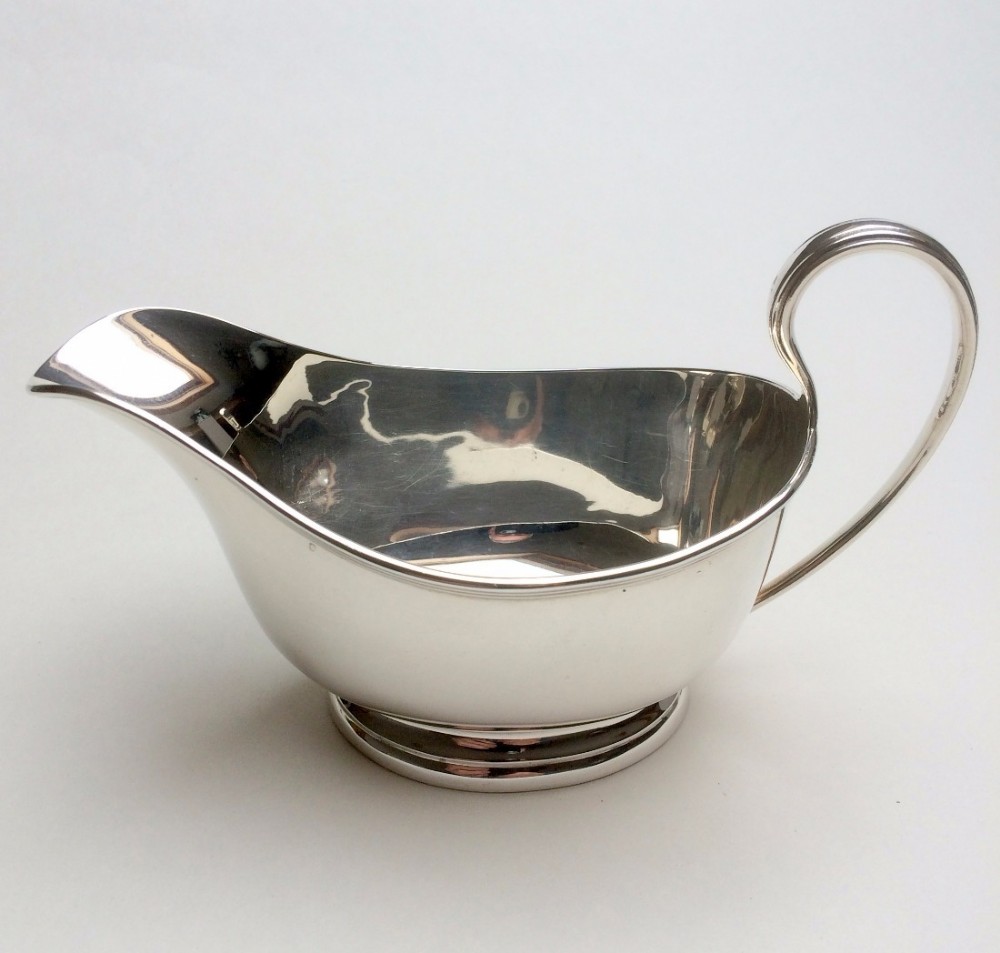 An Art Deco handsome silver gravy boat.