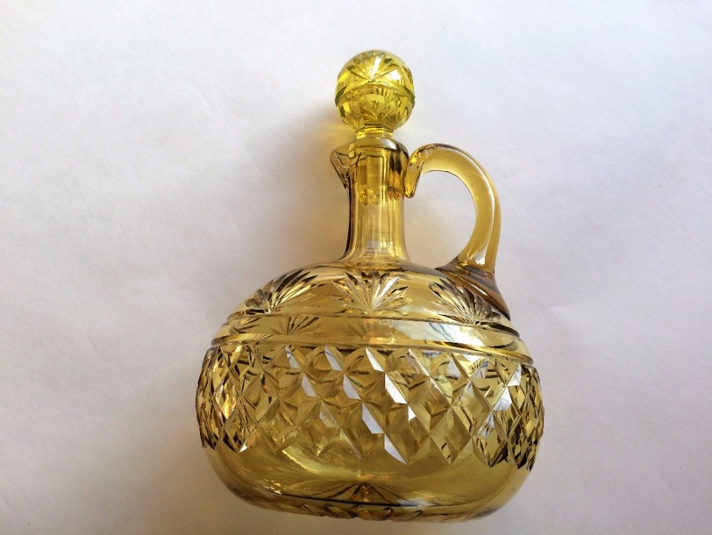 A striking amber cut glass wine jug and stopper by Webb.
