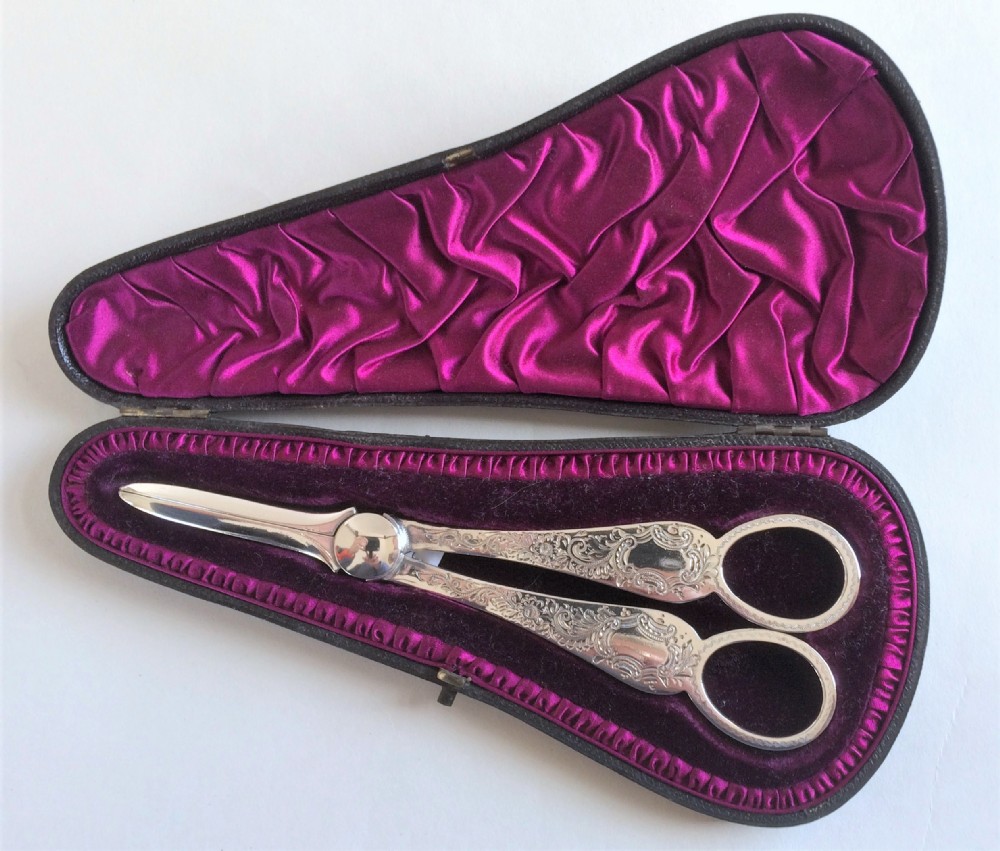 A fabulous pair of boxed Victorian silver grape shears.